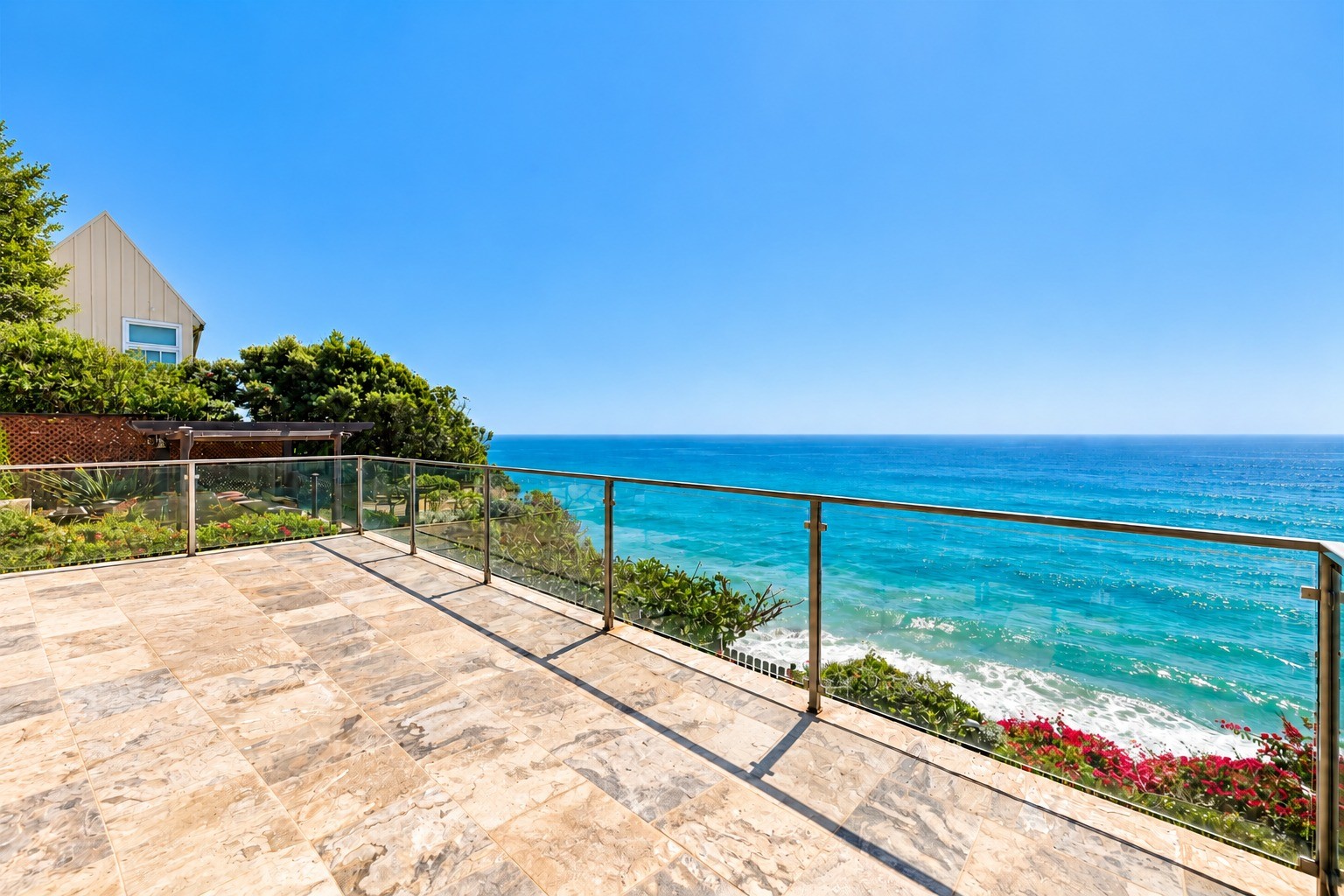Oceanfront terrace with glass railing
